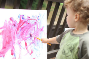 little-boy-painting-on-easel